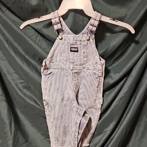 Vintage OshKosh B'gosh baby overalls in a blue and white pinstripe pattern